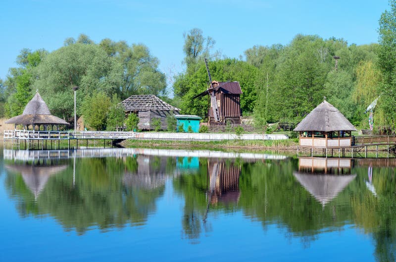 Wooden pergolas on the river bank, mill, summer. Wooden pergolas on the river bank, mill, summer