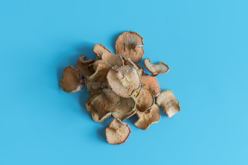 Dried Apples Slice In A Heap On blue Background, Ingredients For Turkish Apple Tea, Close Up. Homemade sun-dried organic apple