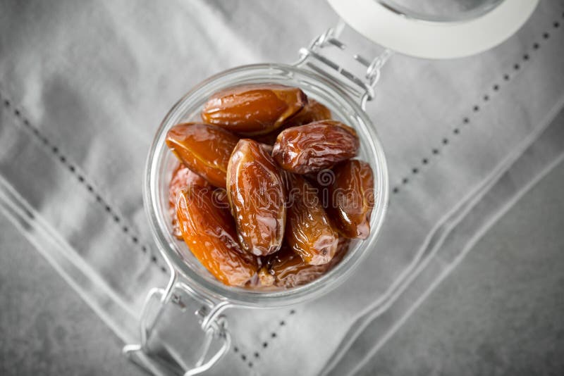 Dried Dates in a Glass Jar on a Light Grey Marble Table Stock Photo ...