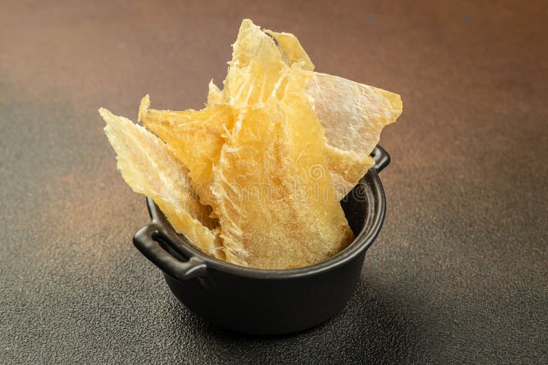 Dried Fish Snack on a Dark Background. Place for Text, Top View Stock