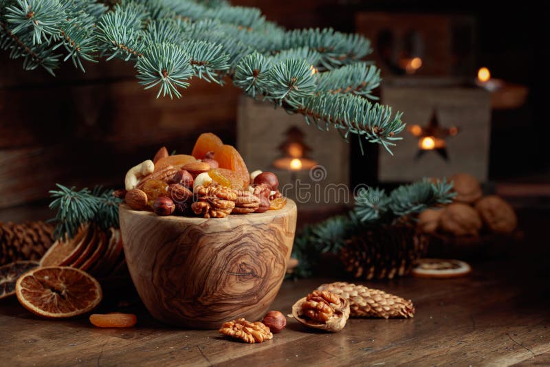 Dried fruits and assorted nuts on an old wooden table