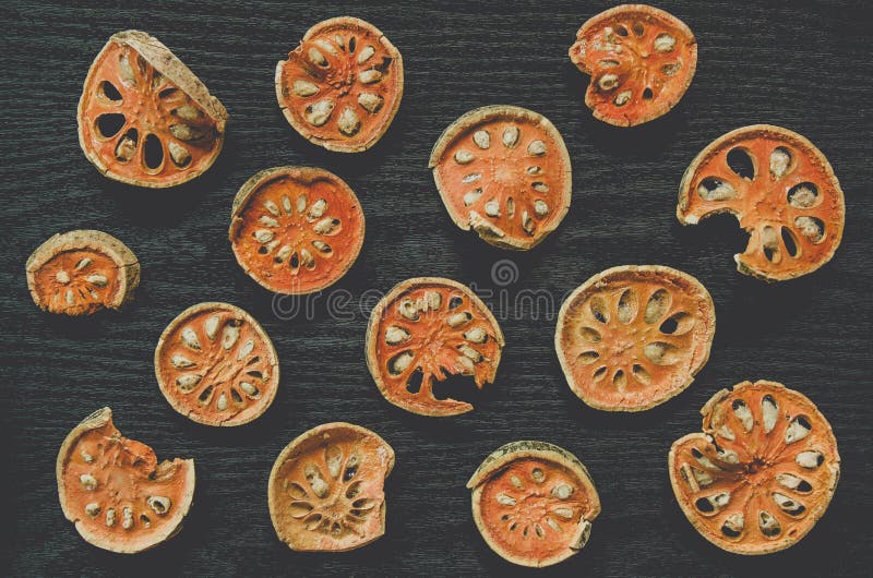Dried herbs and dried bael fruit, Top view of bael dry on the wooden floor stock images Dried herbs and dried bael fruit, Top view of bael dry on the wooden floor stock images
