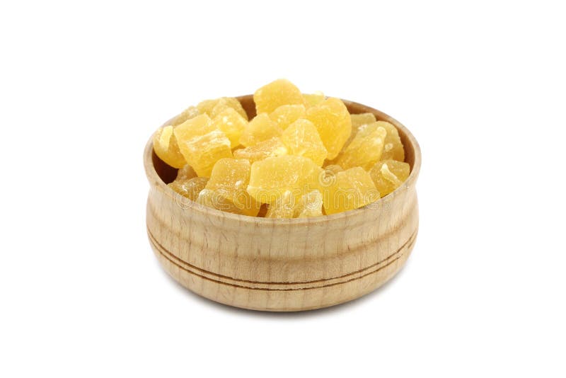 Dried pineapple slices in a wooden dish royalty free stock photography