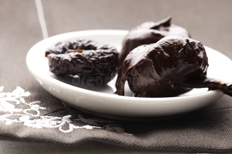 Dried plums in chocolate stock image. Image of black 22607927