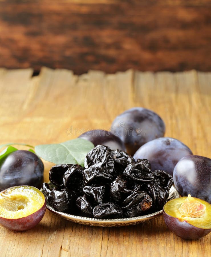 Dried plums prunes and fresh berries