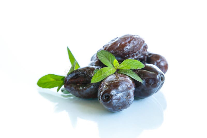 Dried plums with a sprig of mint