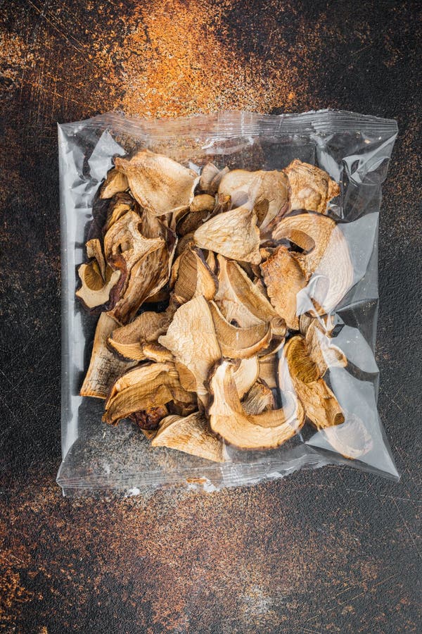 Dried Porcini Mushrooms on Old Dark Rustic Background in Plastic Pack