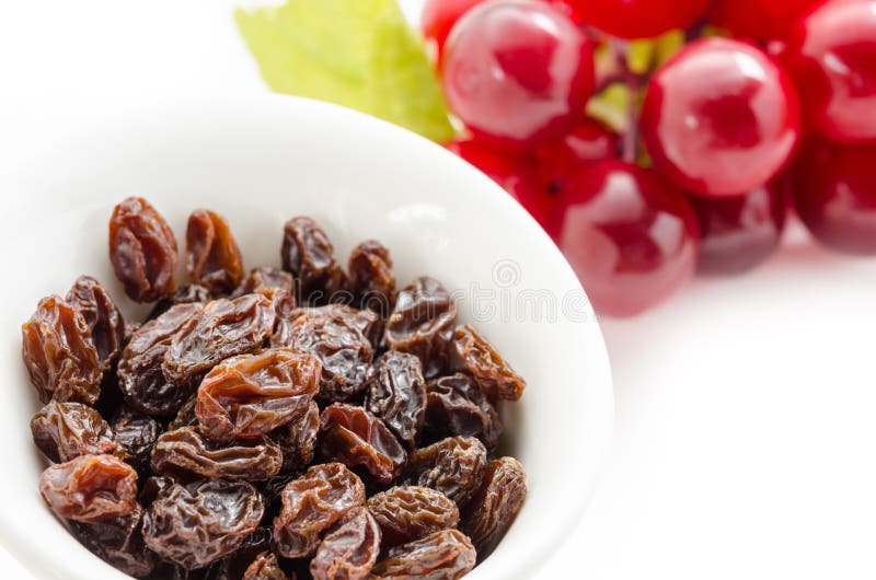 Dried Raisins in White Cup and Fresh Red Grapes. Stock Photo Image of