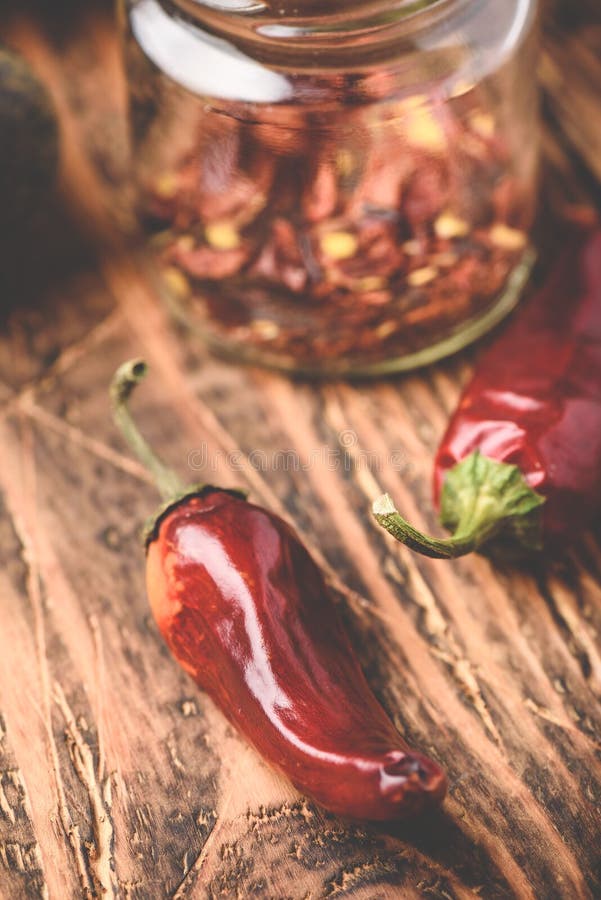 Dried red chili peppers on wooden surface stock image Dried red chili peppers on wooden surface stock image