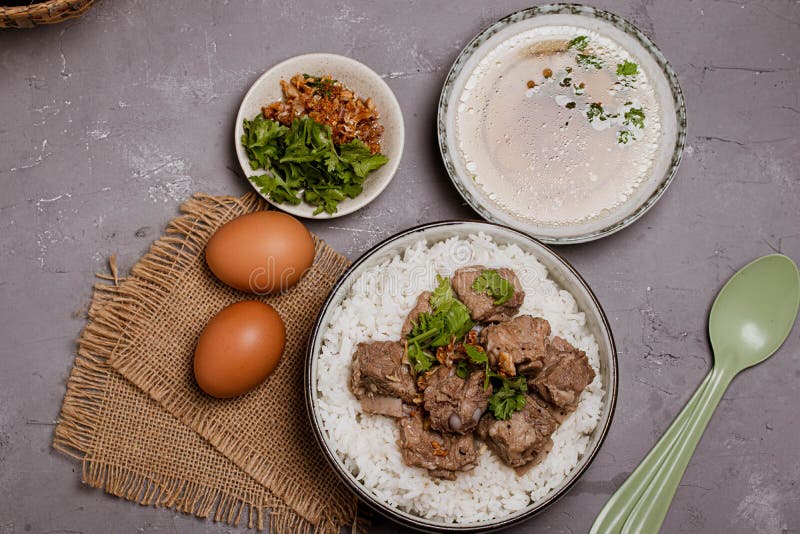 Dried Rice Porridge with Boiled Pork Bones and Broth Stock Photo