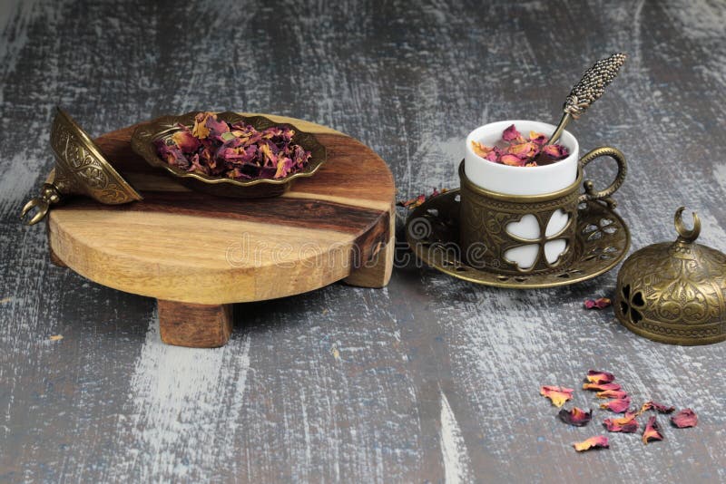 Dried Rose Petals for Making Rose Tea and a Cup of Tea Stock Photo