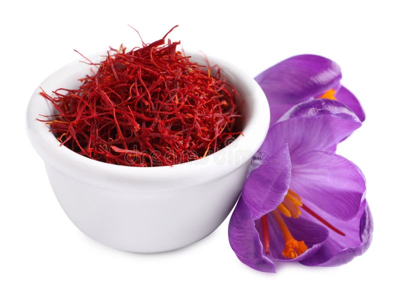 Dried saffron in bowl and crocus flowers on white background stock photos