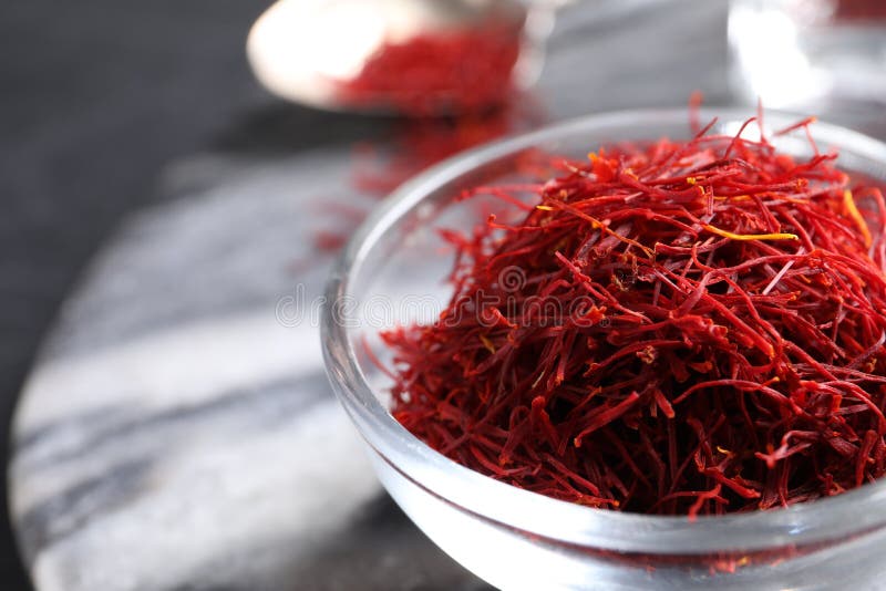 Dried saffron in glass bowl, closeup. Space for text stock images