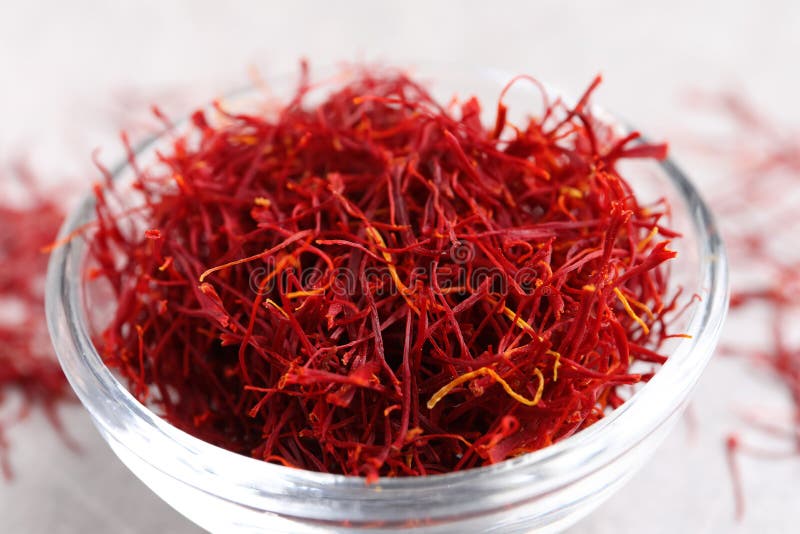 Dried saffron in glass bowl on table, closeup stock image