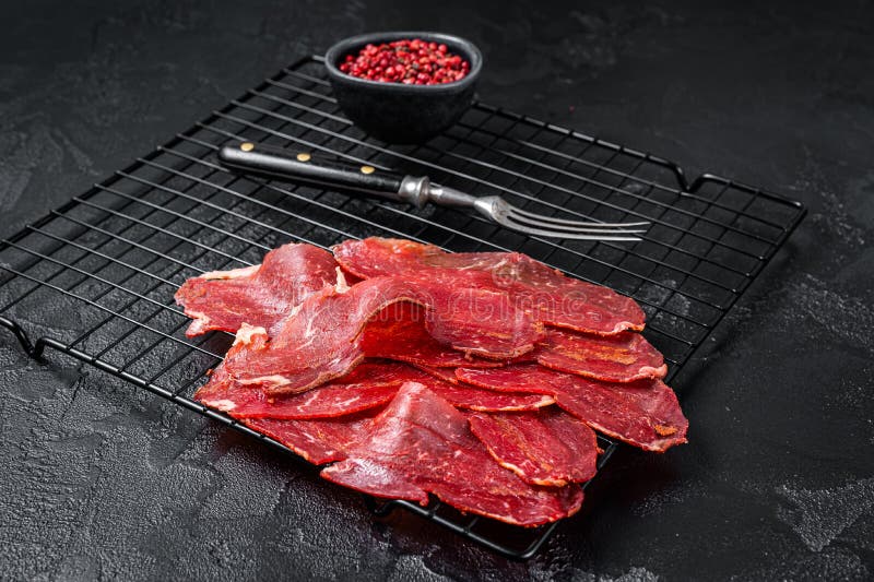 Dried Sliced Basturma, Cured Beef Meat Ready for Eat. Black Background