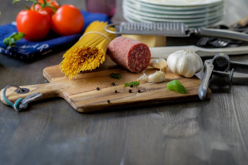 Dried Spaghetti Pasta with Some Salami on the Side and Tomatoes Stock