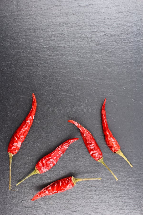 Dried Thai Chili Peppers on a Slate Plate with Copyspace Stock Photo