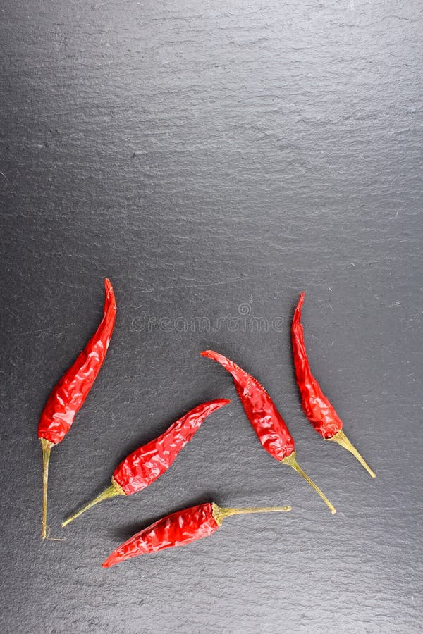 Dried Thai Chili Peppers on a Slate Plate with Copyspace Stock Photo