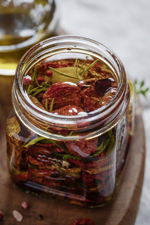 Dried Tomatoes in a Jar with Fresh Spices and Olive Oil Stock Image ...