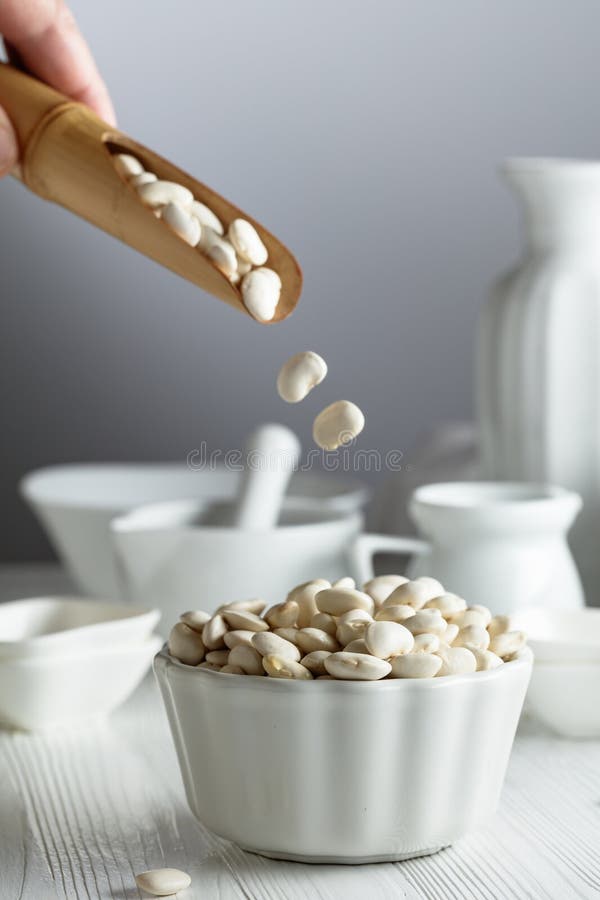 Dried white beans is poured in white bowl royalty free stock photos