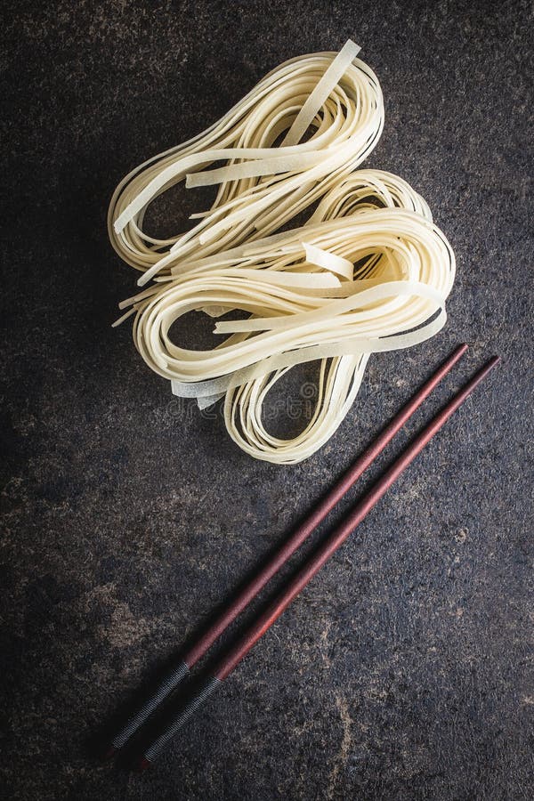 Dried white rice noodles. Raw pasta. Uncooked noodles royalty free stock photos