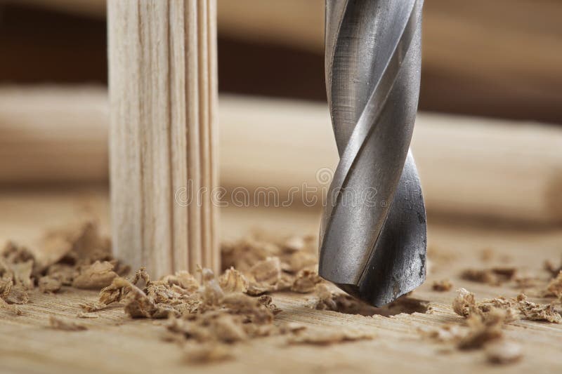 Drill Bit Makes Hole in Wooden Oak Board for Wooden Dowel Stock Photo