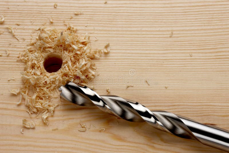 Drill bit next to hole in wood