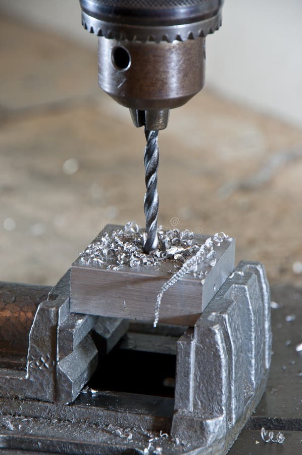 Drilling into a Block of Metal Stock Photo Image of strength