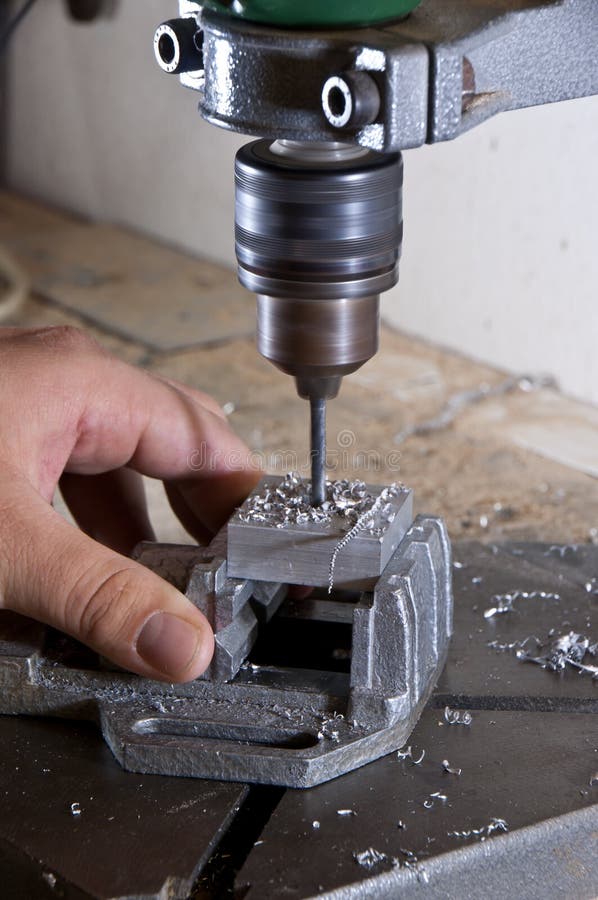 Drilling into a Block of Metal Stock Photo Image of cuttings, metal