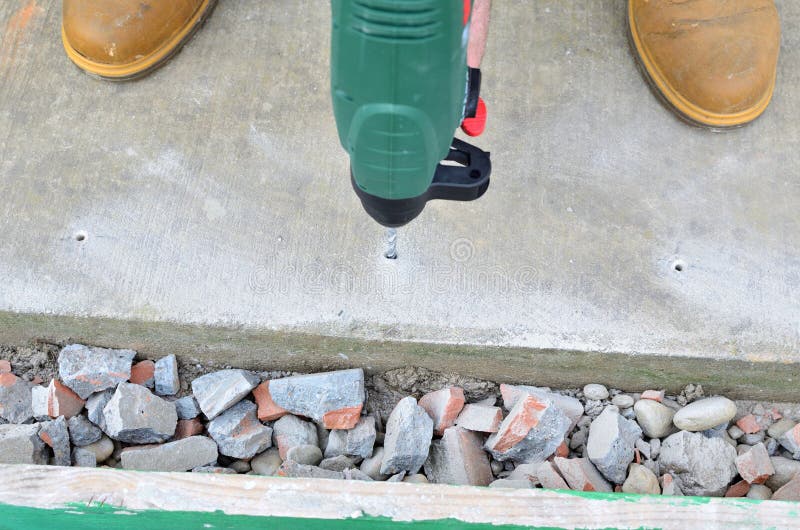 Drilling a Hole in a Wall stock image. Image of foreman 82714349