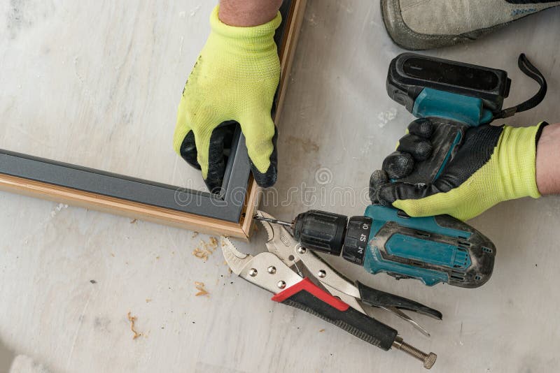 Drilling a Hole in the Door Frame for a Corner Connection. Stock Image