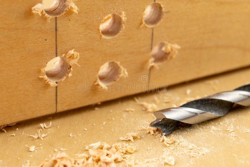 Drilling a Hole in Wood. Wood Drill and Plywood in a Carpentry