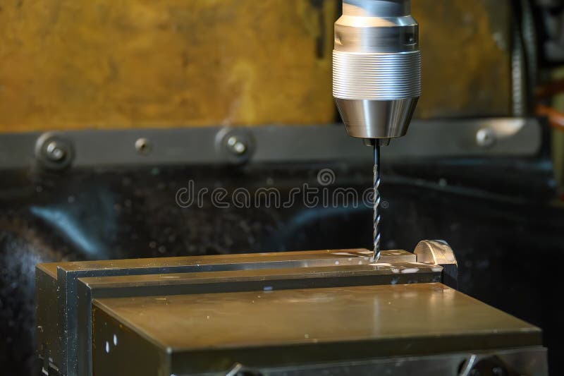 The drilling process the metal plate on NC milling machine royalty free stock photos