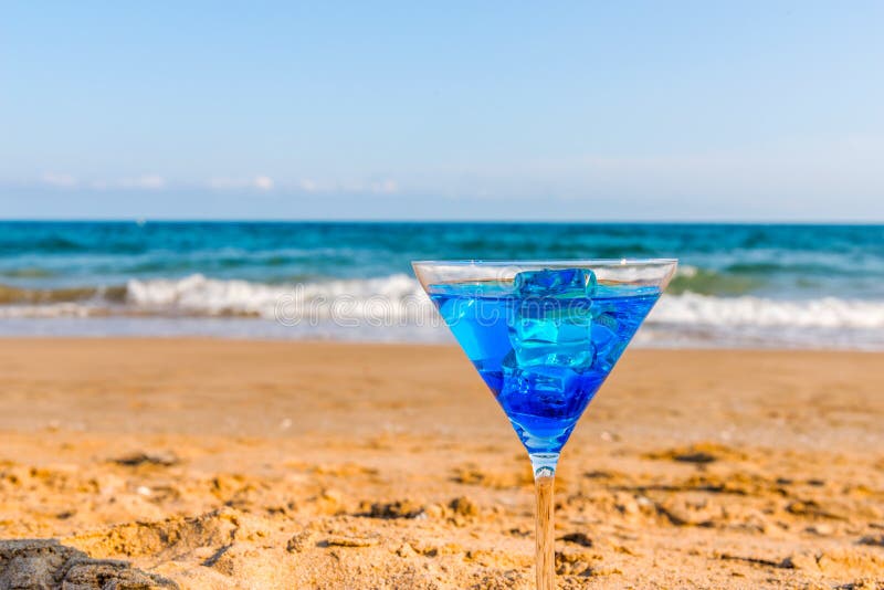 Drink in a Martini Glass on the Background of the Waves Affecting the