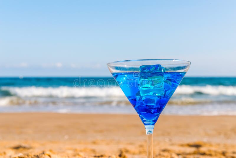 Drink in a Martini Glass on the Background of the Waves Affecting the