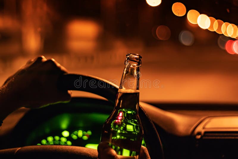 Drinking Beer while Driving Car. Man Hold Bottle Alcohol in Hand at the