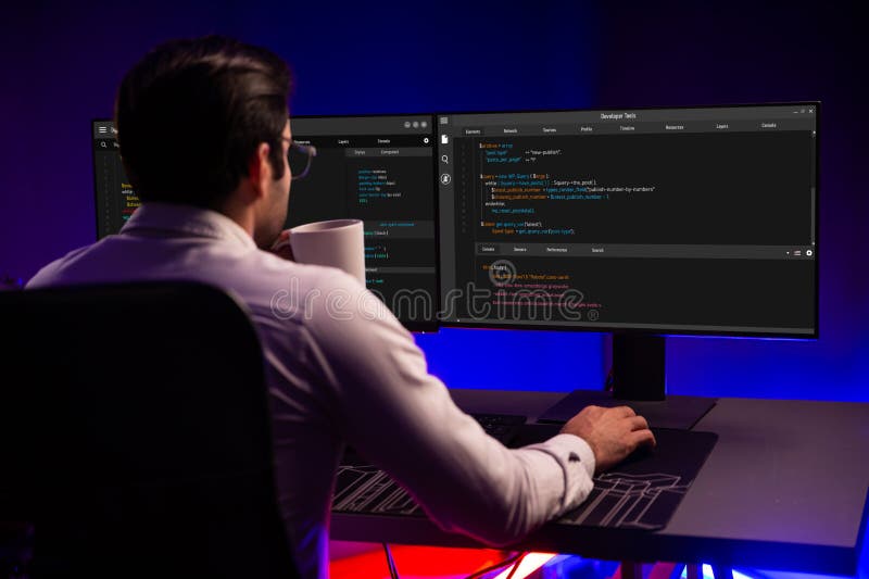 Smart IT developer drinking coffee cup while working in software development coding on pc screen at back side view, presenting program application update online website data at neon office. Surmise. Program coding working stock images, royalty-free photos and pictures
