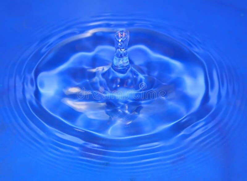 A drip of cool blue water rebounds upwards. Rebounds stock images, royalty-free photos and pictures