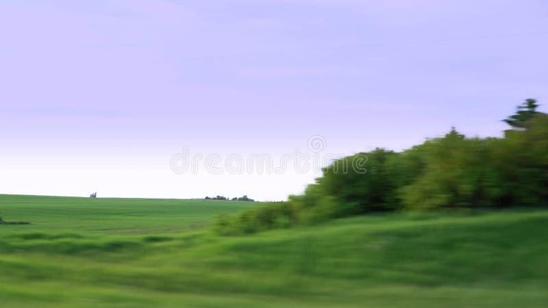 Drive by along farm fields with Grain silos.