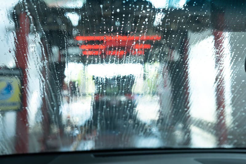 Drive through Car Wash from Inside an Automobile Being Washed Stock