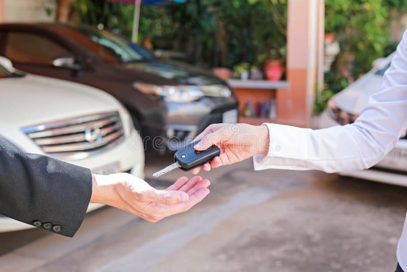 Drive safe. Closeup of a man car owner receiving car keys from t stock photos Drive safe. Closeup of a man car owner receiving car keys from t stock photos