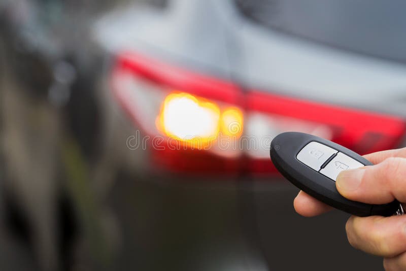 Close Up Of Driver Activating Car Security System With Key Fob royalty free stock photography Close Up Of Driver Activating Car Security System With Key Fob royalty free stock photography
