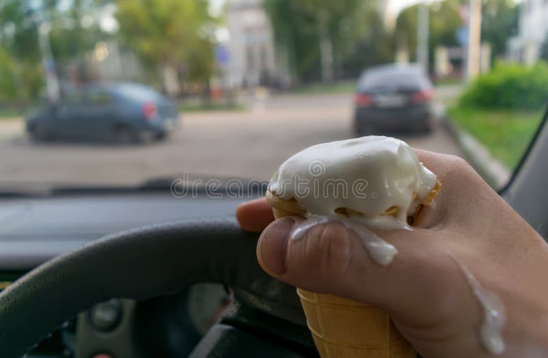 Driver Holds the Ice Cream while Driving a Car Stock Photo Image of