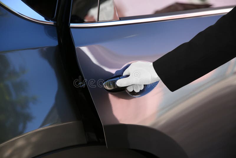 Driver Opening Car Door For Young Businesswoman. Stock Image Image of