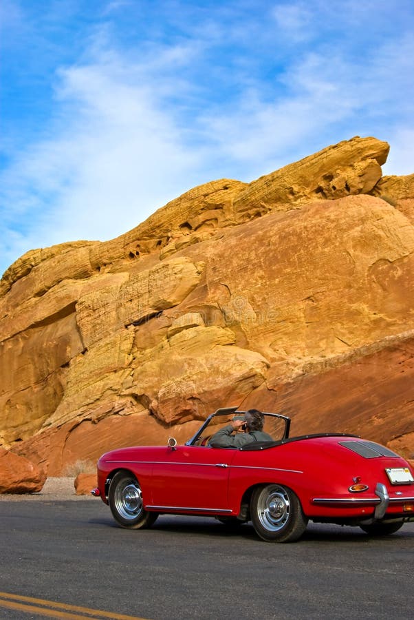 Driver in vintage red car