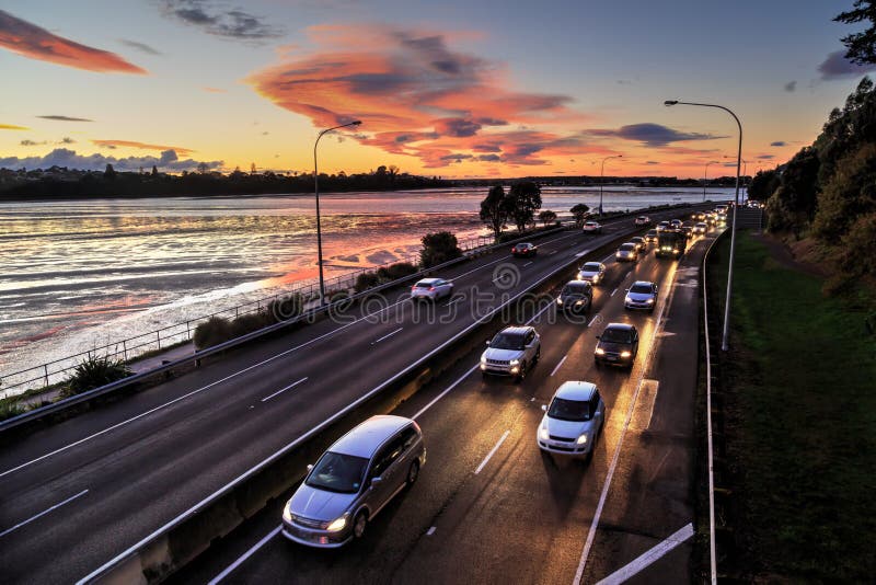 Traffic at sunset, headlights lighting up the road