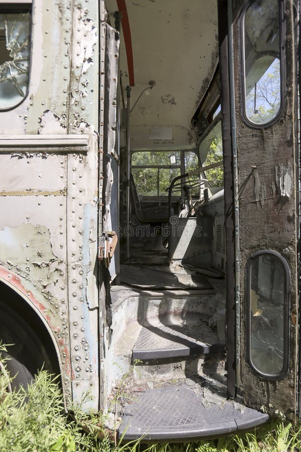 Drivers seat in front abandoned bus. Worn drivers seat and steering wheel in front of abandoned commuter bus with open door royalty free stock images Drivers seat in front abandoned bus. Worn drivers seat and steering wheel in front of abandoned commuter bus with open door royalty free stock images