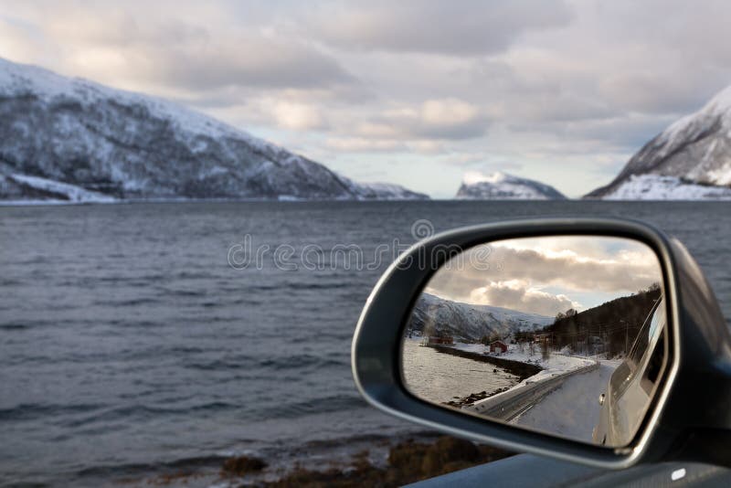 Driving along a fjord in winter Norway