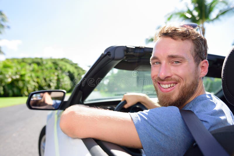 Driving car man happy on road trip travel holidays