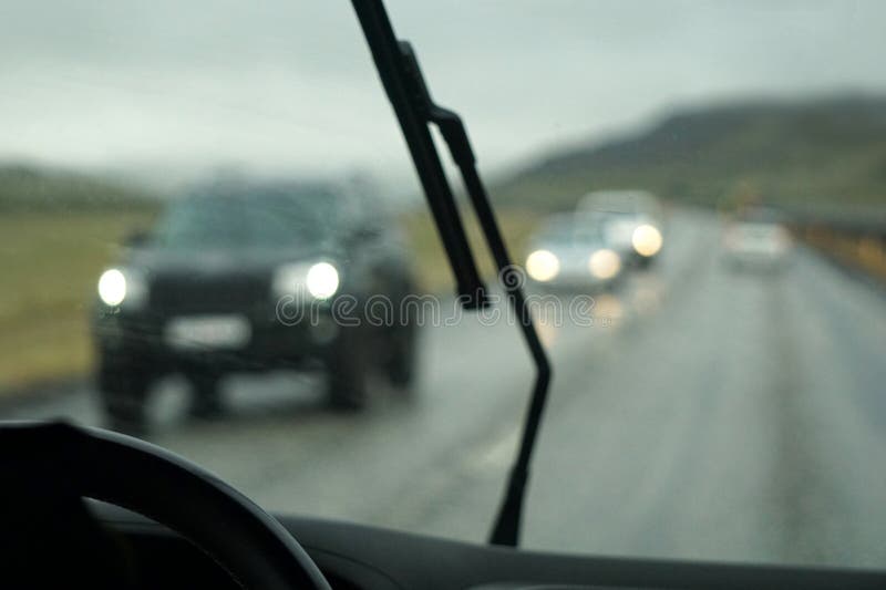 Driving a Car in the Rain with Activated Windshield Wipers Stock Image